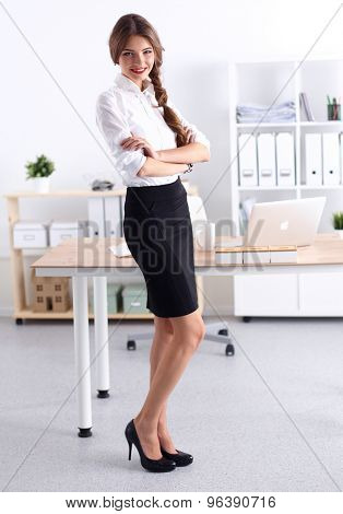 Attractive businesswoman with her arms crossed stnding
