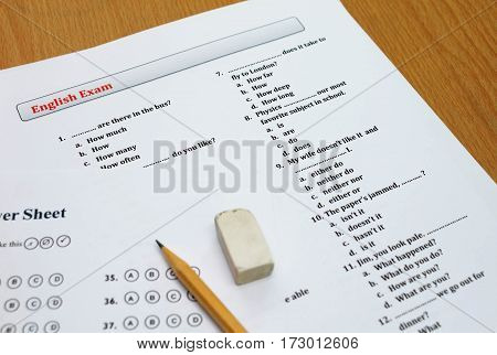 english exam and answer sheet on wooden table