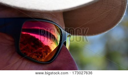 Hyams beach reflected on a red sunglasses. Man in sunglasses with reflective seashore.