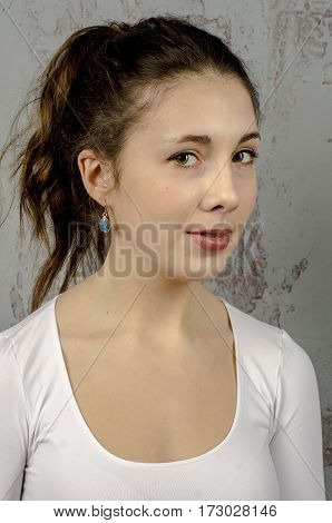 Portrait of a young romantic girl with curly hair and a white blouse