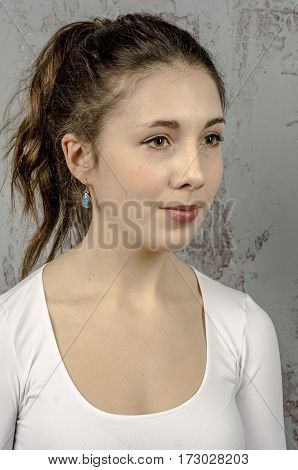 Portrait of a young romantic girl with curly hair and a white blouse
