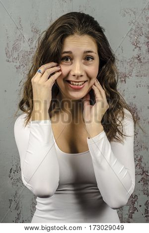 Portrait of a romantic girl in a white brownie sweater
