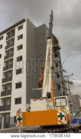 Crane Truck move object to a building in construction site