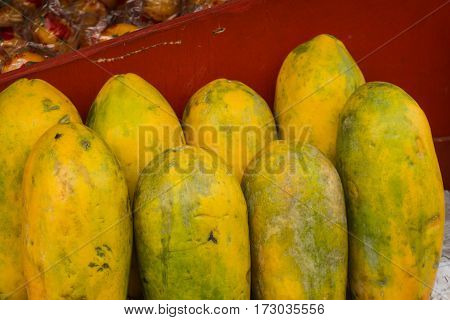 Ripe Papayas with yellow skin displayed on red table in a fruit store photo taken in Depok Indonesia java
