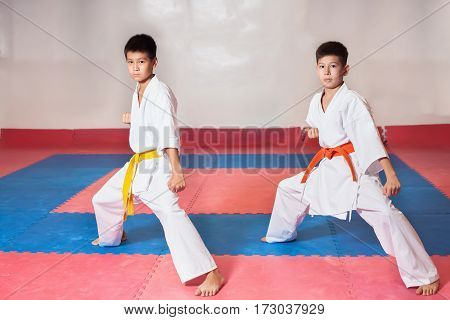Children during training in karate. Fighting position active lifestyle practicing fighting techniques