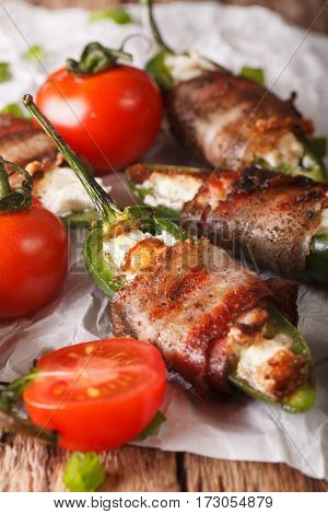 Roasted Jalapeno Peppers Stuffed With Cheese Wrapped In Bacon Close-up. Vertical
