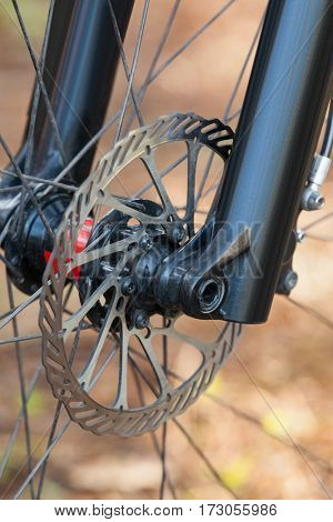 Close-up of mountain bike front wheel with mechanical disc brake