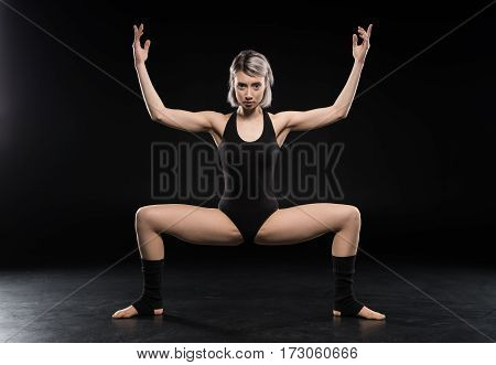 Attractive young woman contemporary dancer posing and looking at camera