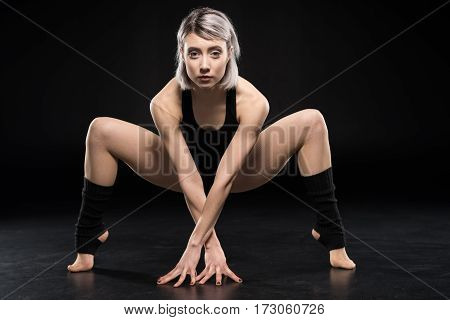 Attractive young woman contemporary dancer posing and looking at camera