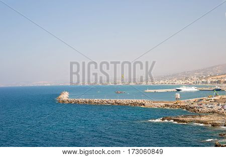 beautiful amazing views from the cliff on the blue azure sea and the port on the island of Crete in Greece
