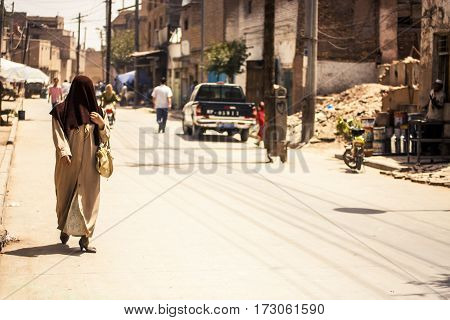 Woman Walking Down Street