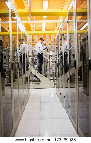 Technician using digital cable analyzer in server room