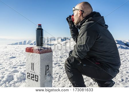 Tourists Drink Hot Tea In The Winter In The Mountains.