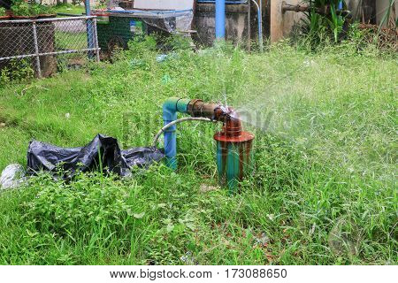plumbing main tube and water leak old tap pipe steel rust on grass floor