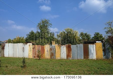 Park of Grugnotorto (Lombardy Italy) between Milan and Brianza in autumn. Colorful fence along a path for bicycle and pedestrian