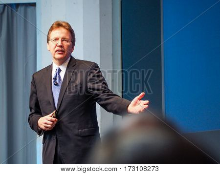 MUNICH GERMANY - FEBRUARY 16 2017: IBM Cognitive Solutions and Research Senior Vice President John Kelly delivers an address to IBM Genius of Things Summit in Munich Germany on February 16 2017.