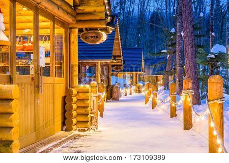 FURANO, JAPAN - FEBRUARY 15, 2017: Ningle Terrace at twilight. The collection of cottages situated in the woods are boutique shops specializing in handmade craft items.