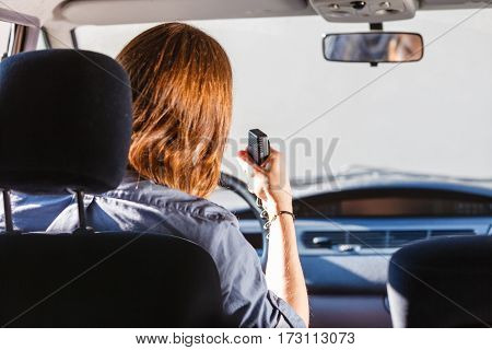 Talking while drive auto walkie talkie comunication concept. Young man driving car using cb radio