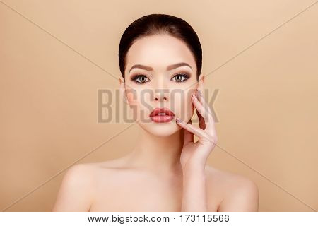Beautiful Face of Young Woman with Clean Fresh Skin close up on beige background. Beauty Portrait. Beautiful Spa Woman Smiling. Perfect Fresh Skin. Pure Beauty Model. Youth and Skin Care Concept
