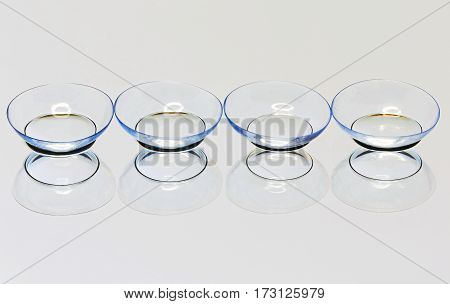 Four soft contact lens on the mirror surface