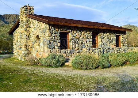 Abandoned historic stone cottage taken on a rural field at Mission Creek in the California Desert
