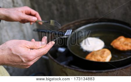 Cook Frying Large Pancakes In A Pan Of Hot Oil In A Street Food