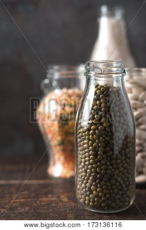 Banks with beans and lentils, rice in line vertical
