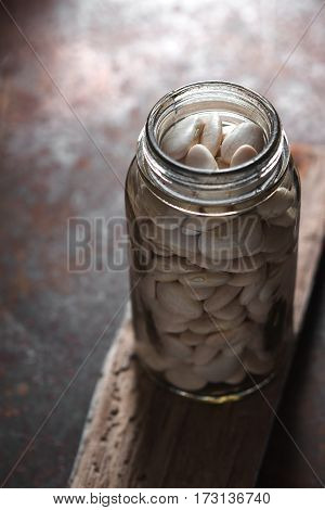 Large white beans in a glass jar vertical