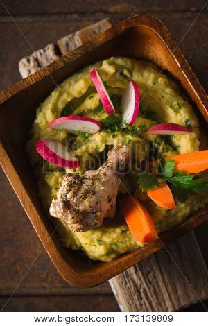 Salad of beans, chicken, carrots, radishes in a bowl top view vertical