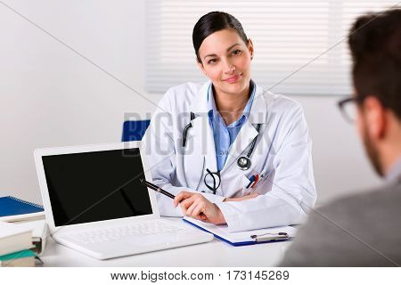 Female Doctor Listening Intently To A Patient