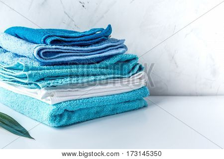 blue towels pile in housekeeping set on laudry gray background mock up