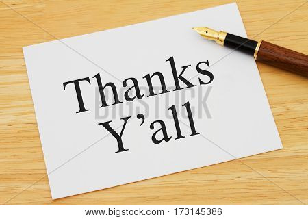 Southern thank you message A white card on a desk with a pen with text Thanks Y'all
