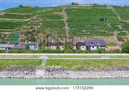 KREMS AUSTRIA - 28TH AUGUST 2015: Buildings along the waterfront in Krems. Wineries can be seen.