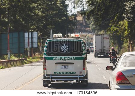 Ambulance driving down a busy road in Guatemala Central America.