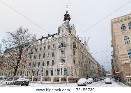 RIGA LATVIA - 3RD JAN 2017: Snowy streets in Riga during the day in the winter. The outside of buildings can be seen.