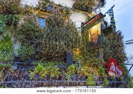 LONDON, ENGLAND - JANUARY 16, 2017 The Churchill Arms Pub Restaurant Kensington London England. Famous pub and restaurant in London. Stared as a pub in 1750. Became Churchill Arms in World War 2 because Churchill's parents used to visit the pub.
