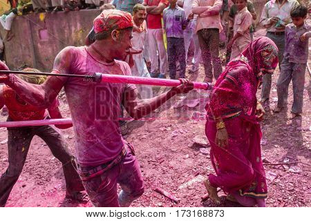 Barsana, India - March 17, 2016: Devotees celebrate Lathmar Holi in Barsana village, Uttar Pradesh, India.