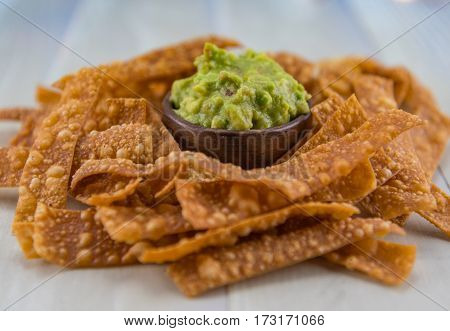 Angle View Bowl Of Guacamole And Chips