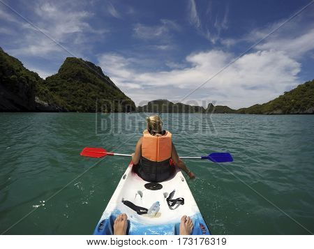 Young woman kayaking in beautiful Ang Thong National Marine Park, Thailand
