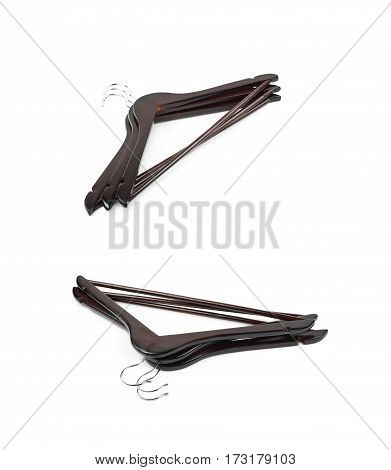 Pile of dark wooden hangers isolated over the white background, set of two different foreshortenings