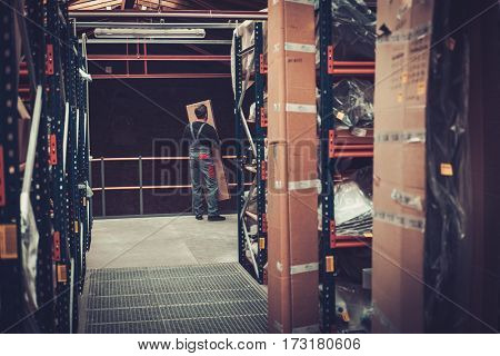Storekeeper moving box on a warehouse