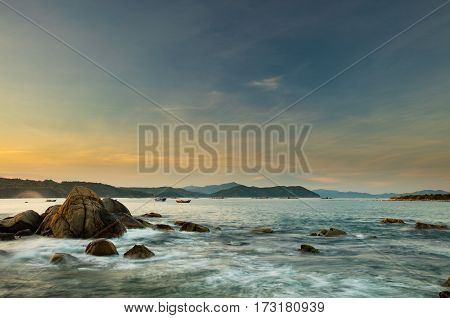 A rocky coastline at sunset looking out over the south China sea in Vung Lam Bay Vietnam.