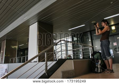 Bucharest Romania August 14 2009: A woman is taking photos in the Henry Coanda airport.