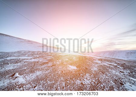 Snow-covered hillsides, Arctic mountain desert. Winter decline