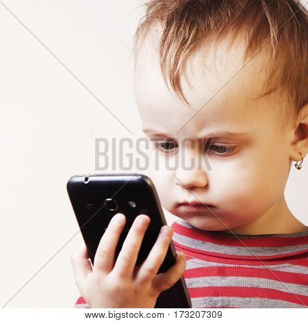 Little beautiful girl with her smart phone (Development education technology information)