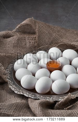 Ecological natural fresh eggs collected on a tray for cooking on the fabric.