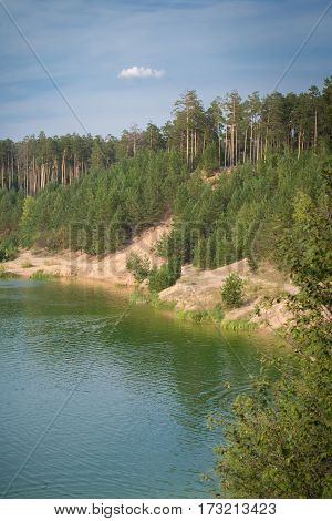 the deep blue of the lake in the forest blue sky summer