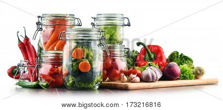 Jars With Marinated Food And Raw Vegetables Isolated On White