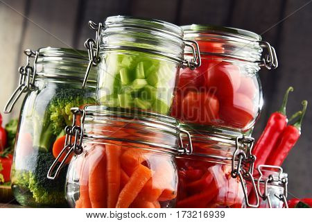 Jars With Marinated Food And Organic Raw Vegetables