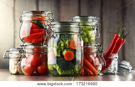 Jars With Marinated Food And Organic Raw Vegetables